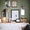 Stylish green living room with gallery wall and sideboard