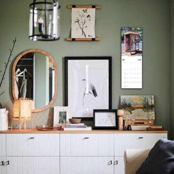 Stylish green living room with gallery wall and sideboard