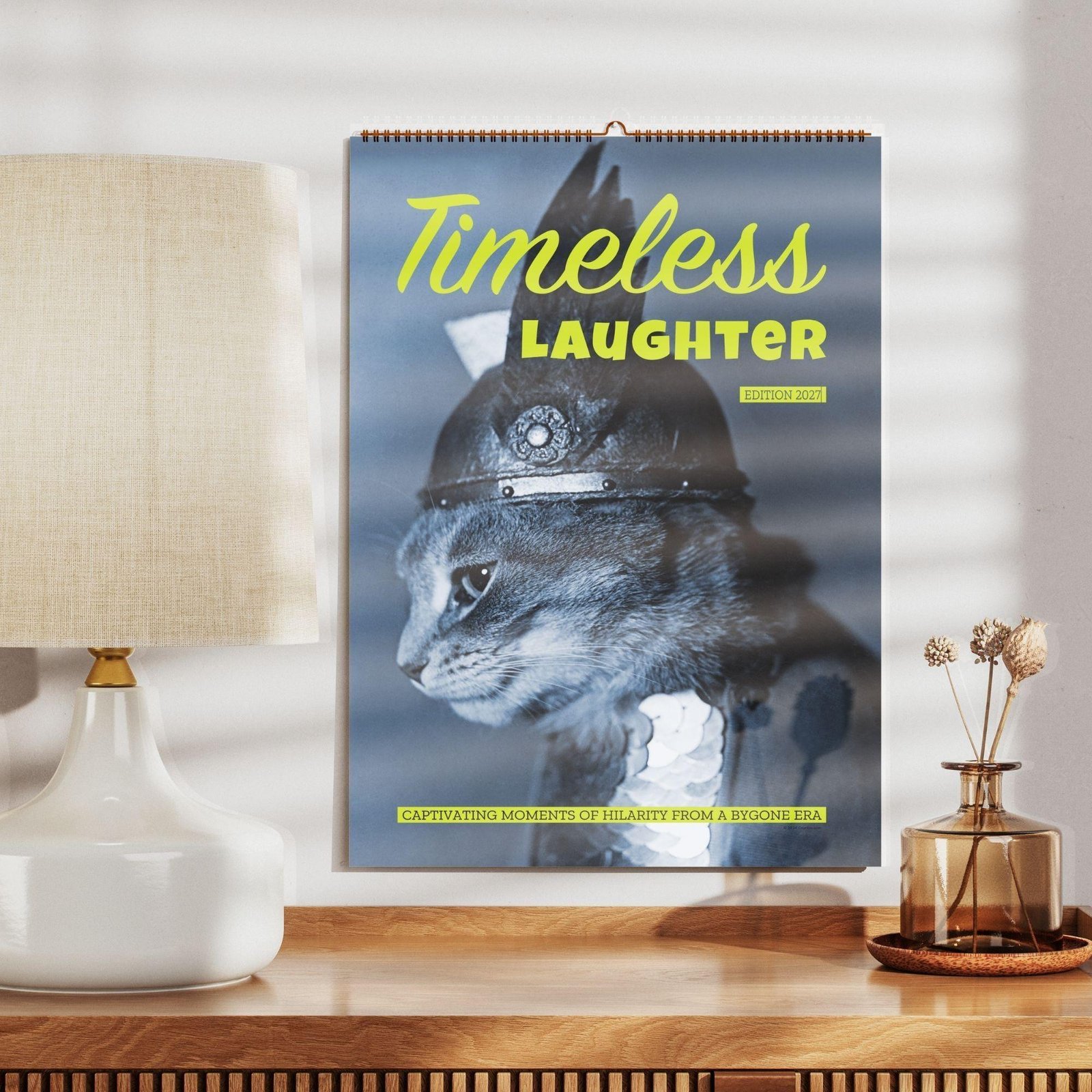 Timeless Laughter 2027 wall calendar featuring cat in armor