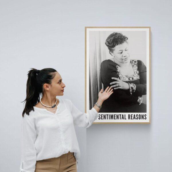 Woman touching framed vintage jazz singer poster